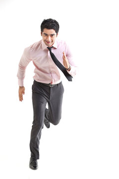 Excited businessman running over white background 