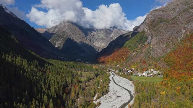 Les Borels village at the entrance of Ecrins National Park. Aerial autumn view in Champoleon Valley with Drac Blanc river. Champsaur, Hautes-Alpes, Alps, France