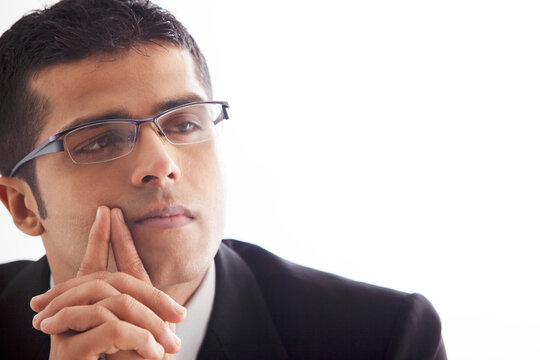 Handsome business man lost in thought 