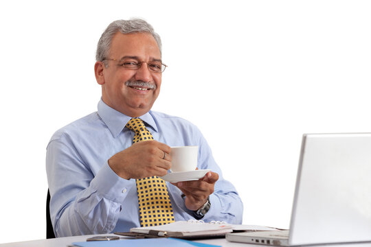 Smiling mature businessman on coffee break 