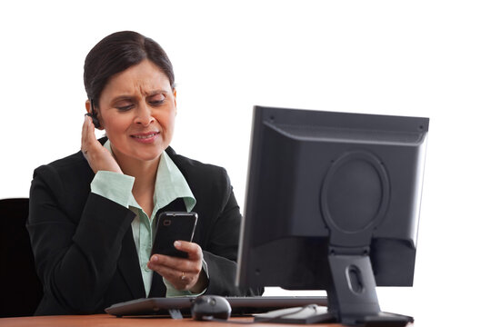 Portrait of mature businesswoman answering phone call 
