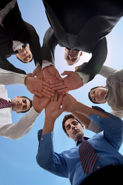Business people stacking hands to show unity 