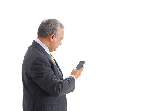 Mature male executive text messaging on white background 