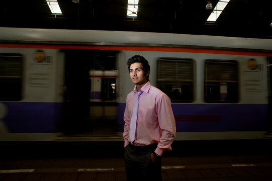 Businessman standing at a train station 