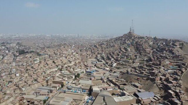 Vast panorama of a densely populated hillside shantytown in san martin de porres district, lima