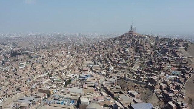 Vast aerial perspective showing the sprawling impoverished neighborhood of cerro la milla in lima
