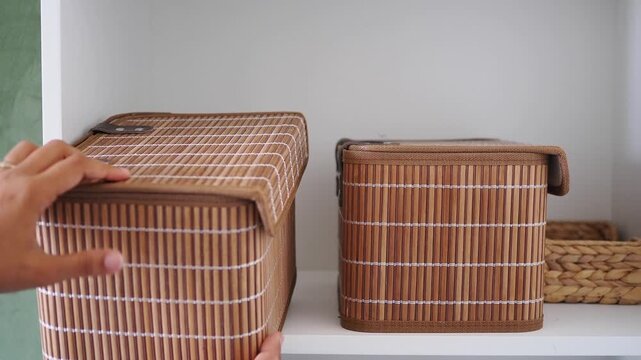 Organizing storage boxes on a white shelf