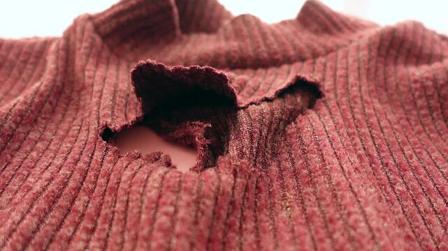 Ripped sweater on a table in a bright space