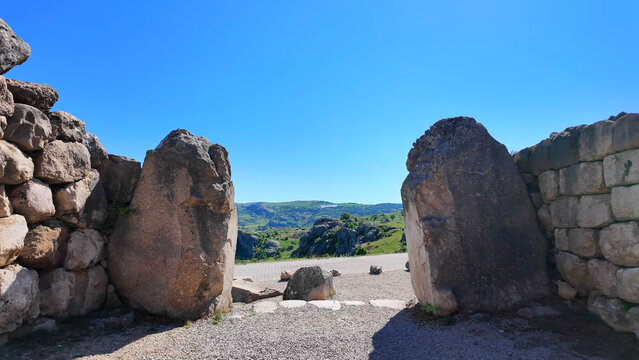 Massive cyclopean megaliths form the imposing structural gateway frames at the ancient Sphinx Gate fortification complex in Hattusa, Turkey.