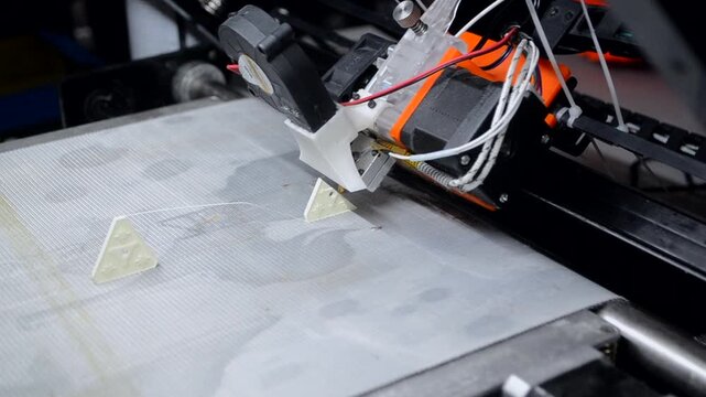 3D printer printing white model. Object printed on 3D printer from molten plastic green color. 3D printed object made from molten green plastic. Additive modern manufacturing. 3D printing technology