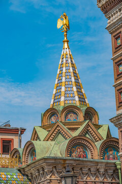 Ornate tiled tent roof of Church of the Savior on Blood with golden eagle and copy space