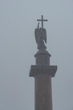 Angel on Alexander Column under dramatic foggy sky with copy space