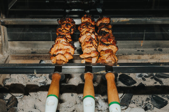 Juicy pork skewers grilling over hot charcoals on barbecue mangal