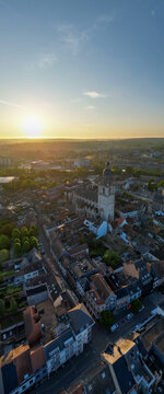 Halle, Vlaams Brabant, Belgium, 27th of April, 2025, Stunning sunset over a picturesque cityscape, showcasing historical architecture and vibrant streets.