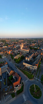Halle, Vlaams Brabant, Belgium, 27th of April, 2025, A breathtaking aerial photograph captures a magnificent cityscape illuminated by the warm, soothing glow of the sunset