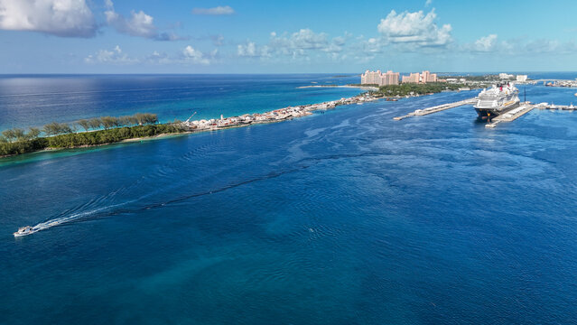 Aerial view of a large cruise ship docked at the port in Nassau with turquoise waters and the coastline of Paradise Island in the background Nassau, New Providence, The Bahamas.