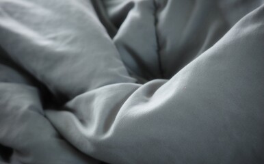 Naklejka premium The dark gray quilted fabric surface is wrinkled