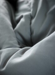 Naklejka premium The dark gray quilted fabric surface is wrinkled