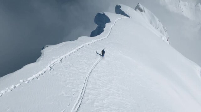 Skier Descending Steep Snow-Covered Mountain Ridge