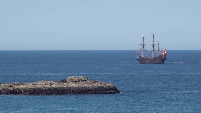 Historic Galleon with Spanish flag sailing close to the coast of Ireland in County Donegal