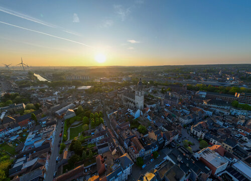 Halle, Vlaams Brabant, Belgium, 27th of April, 2025, A breathtaking aerial photograph beautifully captures a stunning cityscape during sunset, showcasing vibrant colors