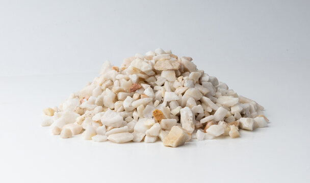 Crushed quartzite pebble pile isolated, white decorative marble stones