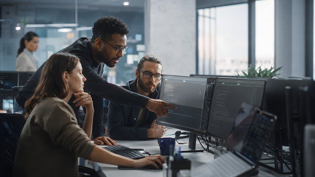 Software Team Collaborating at Office Workstations