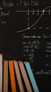 Pile of books and mathematical equations and graphs