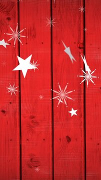 Animation of christmas stars and snowflake falling over red wooden background