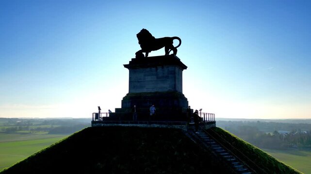 Napoleon Battlefield, Waterloo, Walloon Brabant, Belgium, March 4th, 2025, A majestic lion statue proudly stands atop a hill, surrounded by lush green fields and breathtaking scenic vistas
