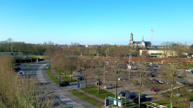 Lier, Antwerp, Belgium, March 5th, 2025, A picturesque aerial view showcasing a city with a vibrant parking lot, clear skies, and lush trees.