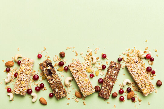 Various granola bars on table background. Cereal granola bars. Superfood breakfast bars with oats, nuts and berries, close up. Superfood concept
