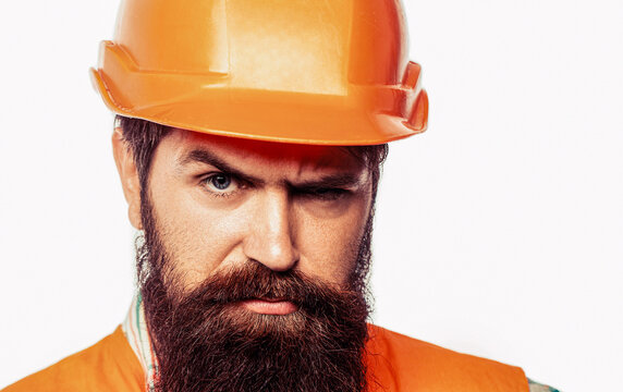 Man worker with beard in building helmet or hard hat. Man builders, industry