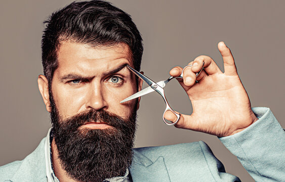 Barber shop. Barber scissors, barber shop. Brutal man, moustache. Male in barbershop, haircut, shaving