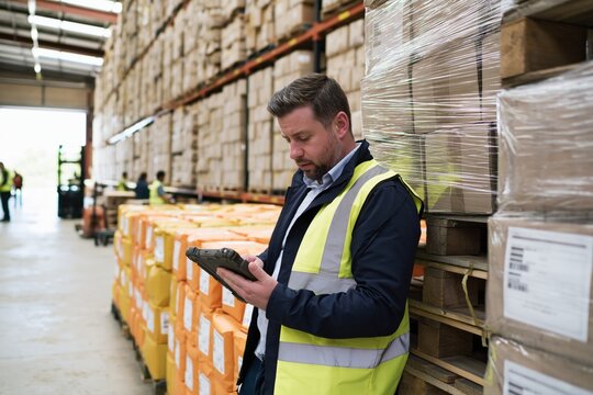 Warehouse worker scanning inventory with handheld device, checking stock levels and managing order fulfillment in distribution center