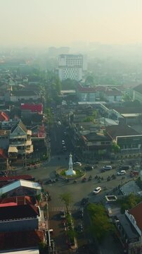 Aerial panorama of Tugu Yogyakarta landmark amid hazy cityscape