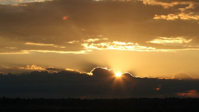 Heavenly Golden Sunrise Breaking Through Storm Clouds