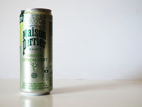 An aluminum can of Maison Perrier Forever Citron Vert sparkling lime water on a white background with copy space.