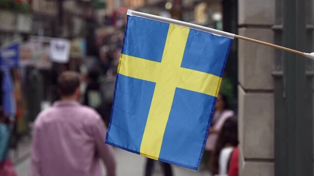 Stockholm Sweden with Swedish flag and people walking