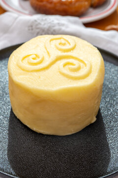 Creamy golden French handmade on farm butter from Brittany with sea salt flavor. Premium artisanal dairy product.