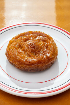 Kouign-amann legendary Breton confection from Douarnenez,  Saint-Malo, Brittany with butter, sugar, puff dough, crispy caramelized layers, authentic French pastry with centuries-old tradition