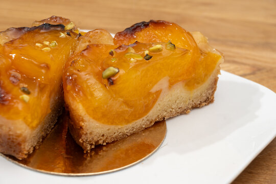Brittany artisan bakery apricot tart with thinly sliced, caramelized apricots on buttery pastry with glossy glaze; sweet, French breakfast in bakery