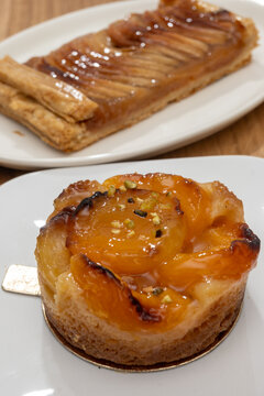 Brittany artisan bakery apricot tart with thinly sliced, caramelized apricots on buttery pastry with glossy glaze; sweet, French breakfast in bakery