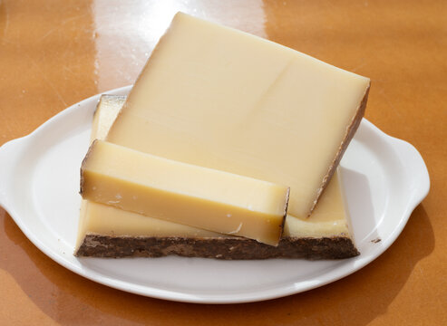 Comte hard french cheese from France's Jura Mountains made from unpasteurized cow's milk with traditional methods in cooperative dairies with nutty flavor, creamy texture, aged in natural caves