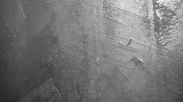 A smooth upward camera movement reveals a striking black side wall adorned with intricate patterns, showcasing a gorgeous texture, striking artistic details, and cutting-edge architectural features.