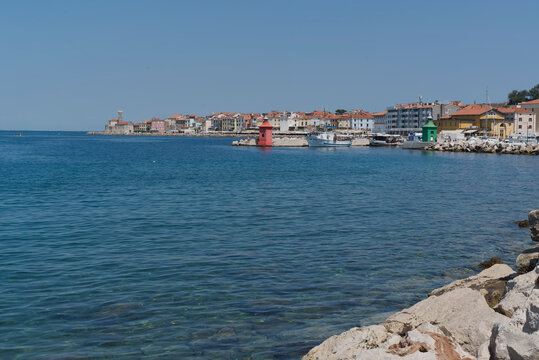 View of the Adriatic Sea and historic Piran old town on the Slovenian coast, with colorful buildings along the waterfront