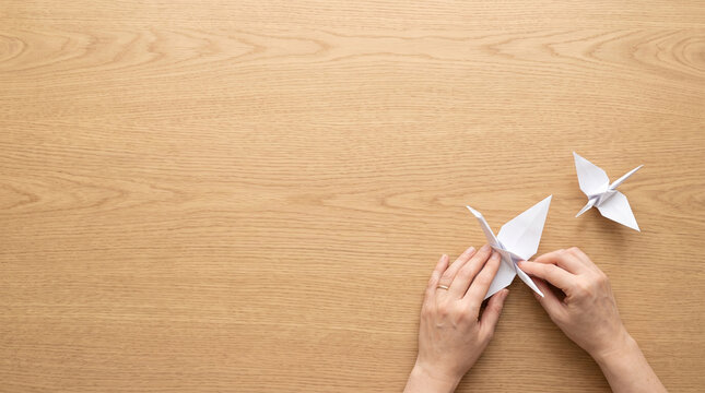 Top view origami on oak desk with copy space