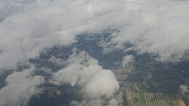 aerial view of amsterdam from the plane entry to the airport with clouds in the sky