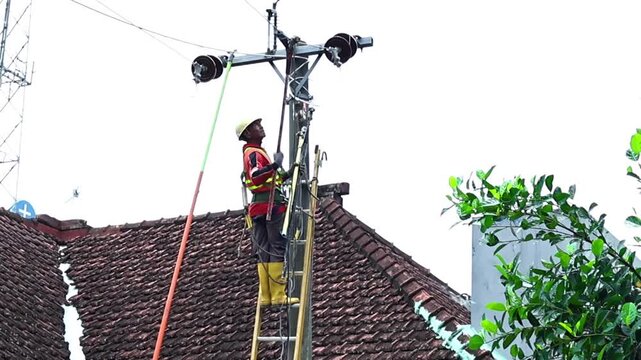 Electrical technicians practicing grounding installation during technical safety training