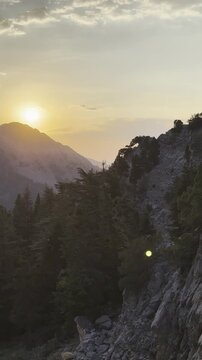 sunsets over the peaks, jagged mountains, mountain ranges in the background, and mystical natural landscapes.